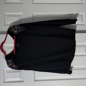 Rebel Wilson for torrid black sweater with beading on shoulder.